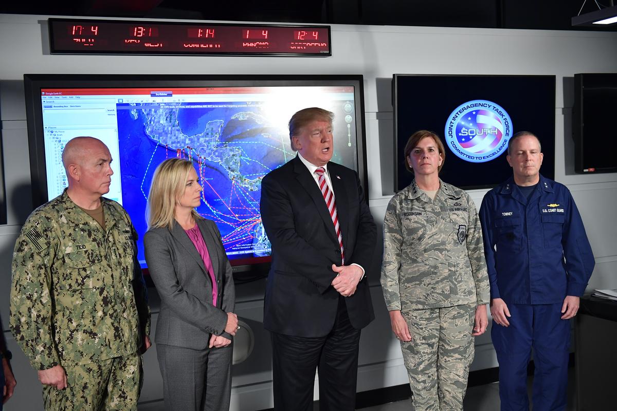 President Donald Trump, flanked by Homeland Security Secretary Kirstjen Nielsen (C-L), tour Joint Interagency Task Force South, a federal anti-smuggling and anti-drug trafficking agency, at the Naval Air Station Key West in Key West, Florida on April 19, 2018. (MANDEL NGAN/AFP/Getty Images)