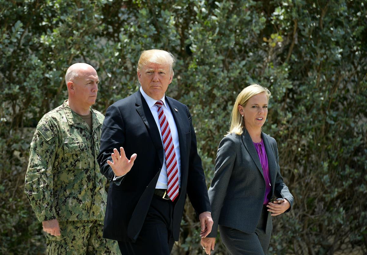 President Donald Trump walks with Admiral Kurt Walter Tidd, Commander of the United States Southern Command, and Homeland Security Secretary Kirstjen Nielsen as he visits Joint Interagency Task Force South at Naval Air Station Key West on April 19, 2018. (MANDEL NGAN/AFP/Getty Images)