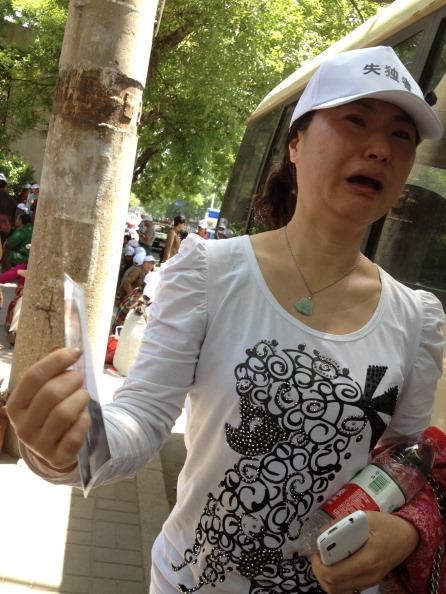 Gao Huaping, 44, of Chengdu, whose son died of illness last year expresses her frustration with the Chinese Communist regime, which brutally enforced the one-child policy, in Beijing on May 20. (William Wan/The Washington Post via Getty Images)