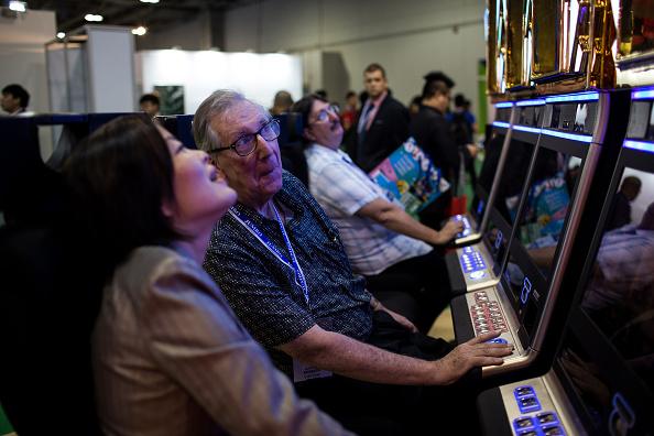 An attendee plays a gaming machine at the Global Gaming Expo (G2E) inside the Venetian Macau resort and casino, operated by Sands China Ltd., a unit of Las Vegas Sands Corp., in Macau, China, on May 19, 2015. (Billy H.C. Kwok/Bloomberg via Getty Images)