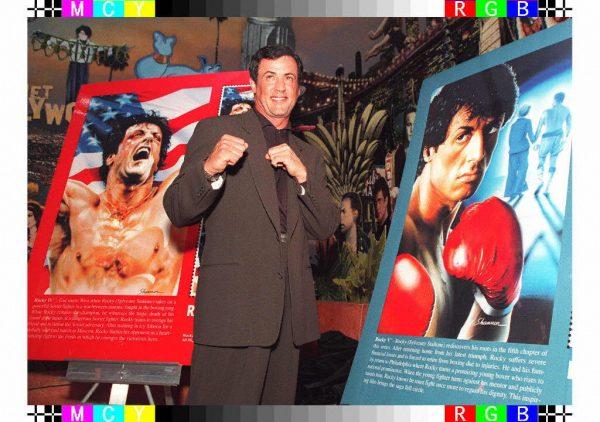 Actor Sylvester Stallone poses for photographers in front of two replicas of new postage stamps featuring Stallone in the Rocky movies in N.Y. (Jon Levy/AFP/Getty Images)
