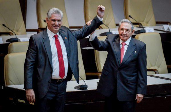 Cuban President Miguel Diaz-Canel (L) reacts as former President Raul Castro raises his hand during the National Assembly in Havana, on April 19, 2018. (Reuters/Adalberto Roque/Pool via Reuters)