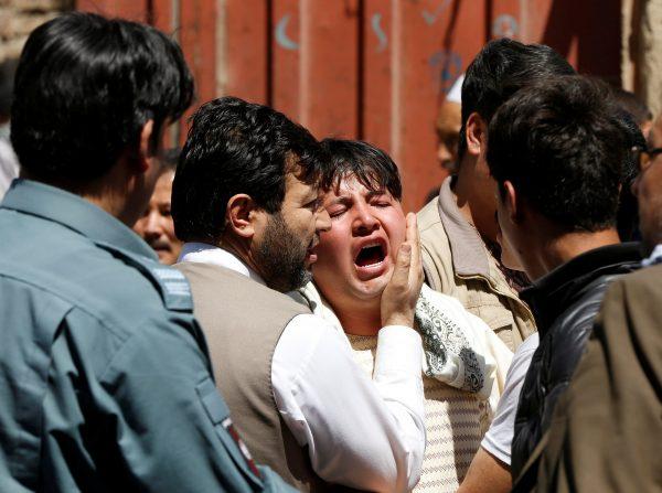 A man reacts as others comfort him at the site of a suicide attack in Kabul, Afghanistan April 22, 2018. (Reuters/Omar Sobhani)