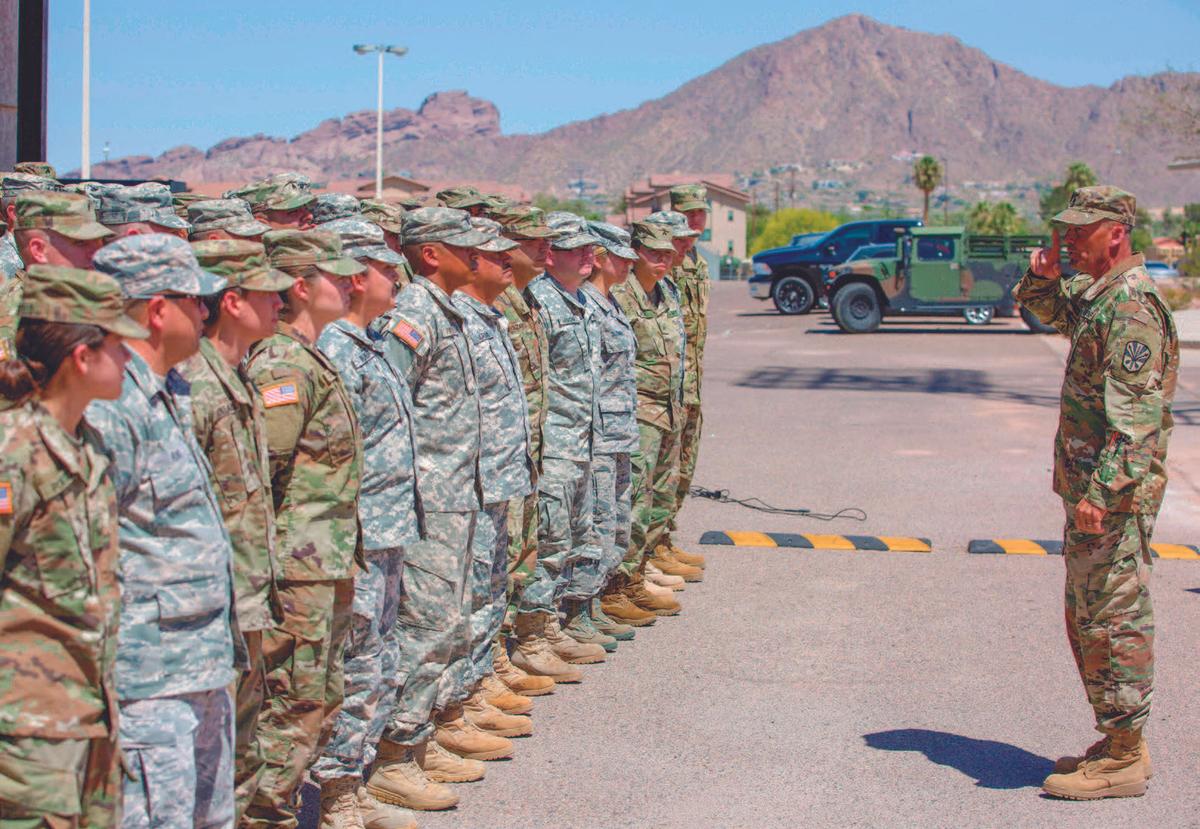 Members of the Arizona National Guard listen to instructions at the Papago Park Military Reservation in Phoenix on April 9. (CAITLIN O’HARA/AFP/GETTY IMAGES)
