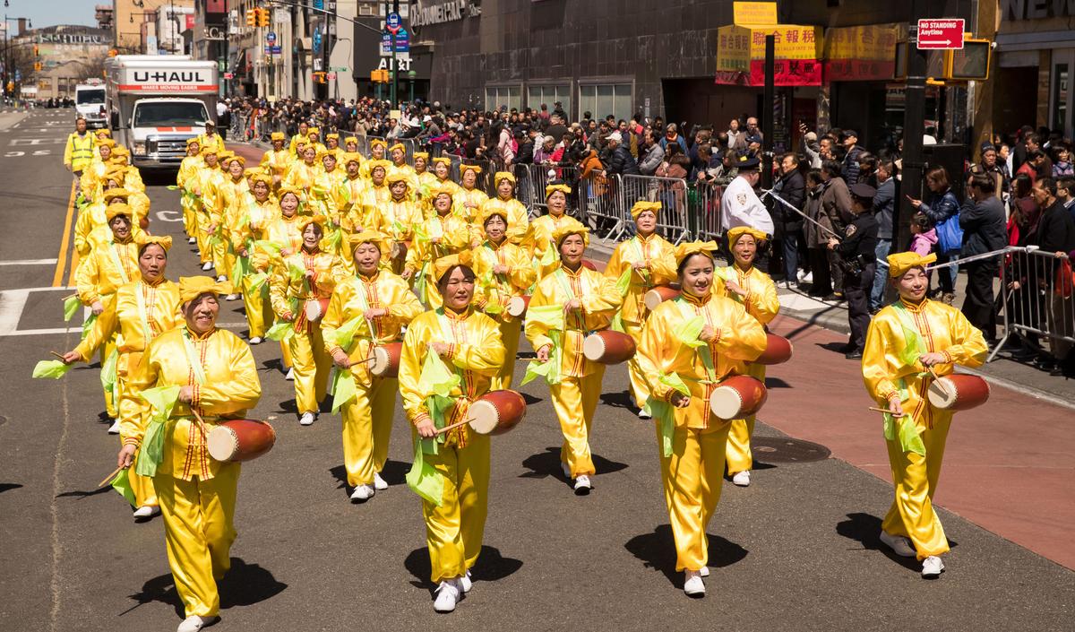 A waist drum troupe, made up of Falun Gong practitioners, marches in a parade in Flushing, New York, on April 22, 2018, to commemorate the 19th anniversary of the April 25th peaceful appeal of 10,000 Falun Gong practitioners in Beijing, China. (Larry Dai/The Epoch Times)