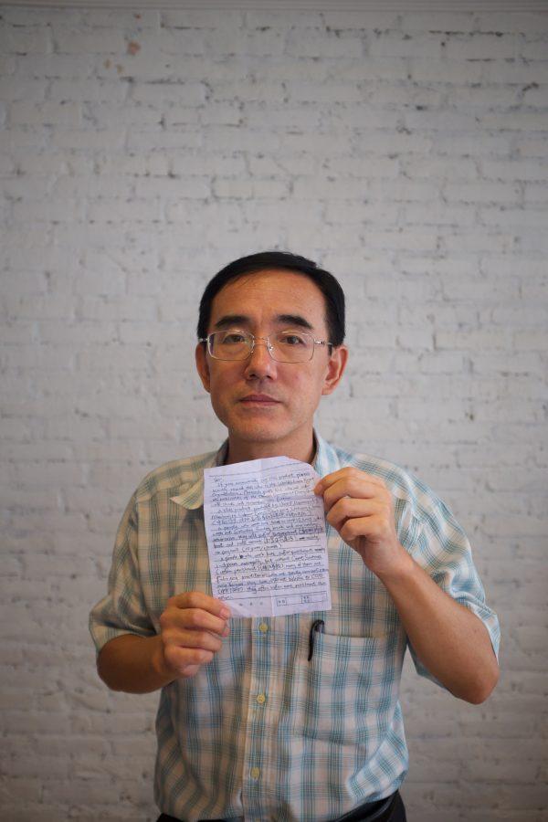 Sun Yi holding the SOS letter he wrote, that made its way around the world and back to<br/>him. (Courtesy Flying Cloud Productions)