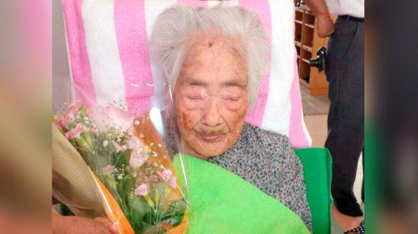 Nabi Tajima, born in 1900, holds a bouquet in Japanese southwestern island of Kikaijima, Kagoshima Prefecture, Japan, in this photo taken in 2015 and released by Kyodo. (Kyodo/via REUTERS)