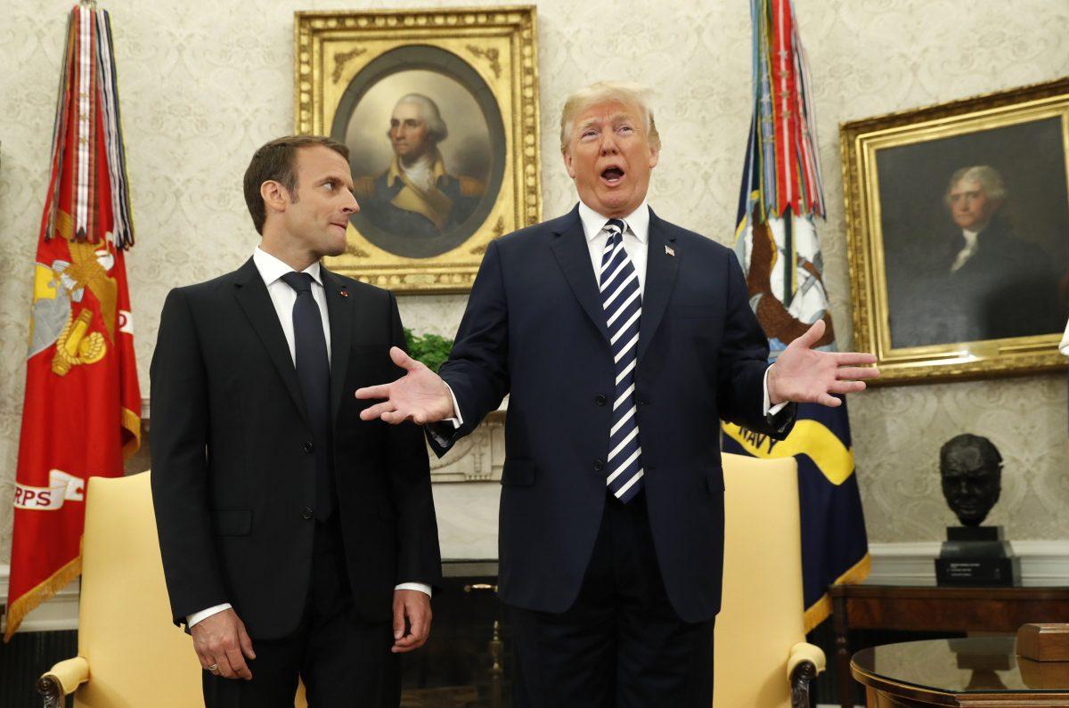 French President Emmanuel Macron (L) looks on as President Donald Trump speaks during their meeting in the Oval Office following the official arrival ceremony for Macron at the White House in Washington on April 24, 2018. (REUTERS/Kevin Lamarque)