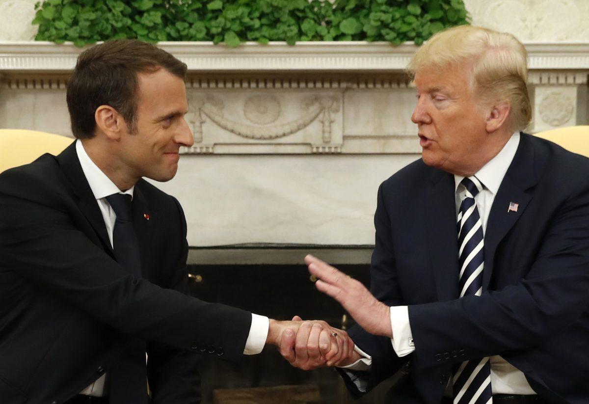 French President Emmanuel Macron (L) and President Donald Trump shake hands during their meeting in the Oval Office following the official arrival ceremony for Macron at the White House in Washington on April 24, 2018. (REUTERS/Kevin Lamarque)
