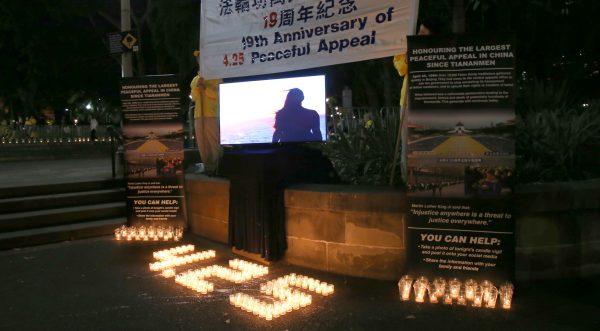 Falun Gong practitioners gather for a candlelight vigil to continue their journey of peaceful appeal for freedom of belief in China in Sydney, Australia. (Linda Zhang/The Epoch Times)