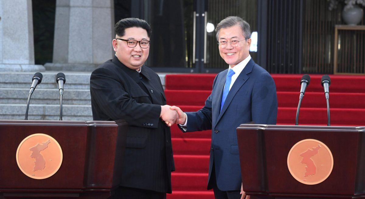 South Korean President Moon Jae-in (R) and North Korean leader Kim Jong Un shake hands at the truce village of Panmunjom inside the demilitarized zone separating the two countries on April 27, 2018. (Korea Summit Press Pool via Reuters)