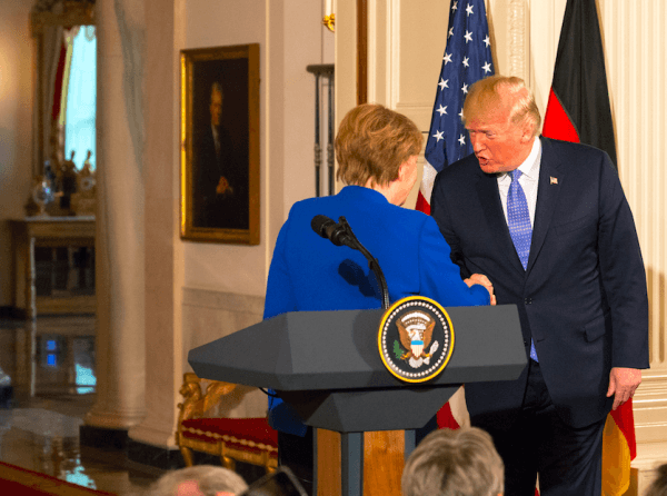 German Chancellor Angela Merkel and U.S. President Donald Trump shake hands at the conclusion of a joint press conference at the White House in Washington on April 27, 2018. (Charlotte Cuthbertson/The Epoch Times)