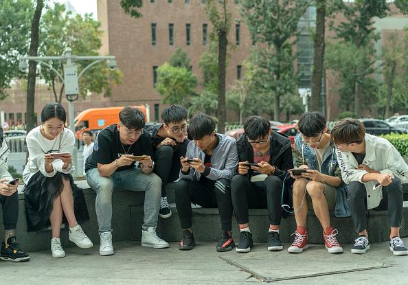 Young players practice outside the shopping mall, where a battle match of mobile game <span style="font-weight: 400;">Honor of Kings</span> is held in Tianjin, China, on Oct. 1, 2017. (Zhang Peng/LightRocket via Getty Images)