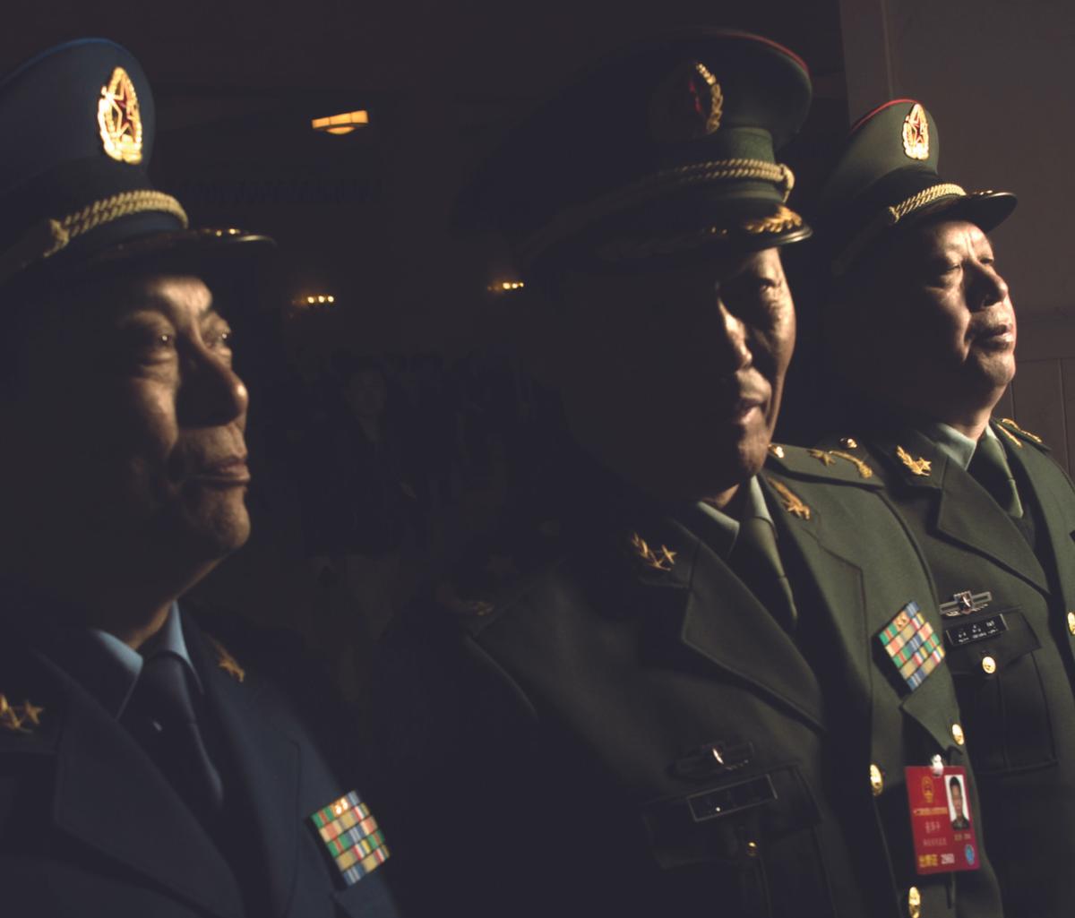 Military delegates leave after the 2nd plenary session of the National People’s Congress in Beijing on March 9, 2016. (FRED DUFOUR/AFP/GETTY IMAGES)