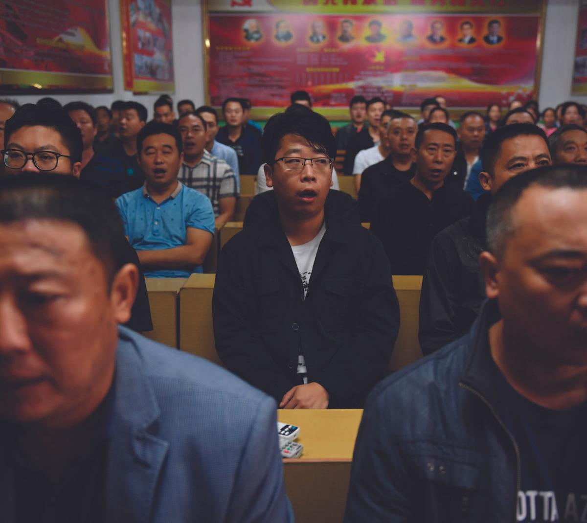 Factory managers sing communist red songs at the start of their work day in Nanjie Village, in China’s central<br/>Henan Province, on Sept. 27, 2017. (GREG BAKER/AFP/GETTY IMAGES)