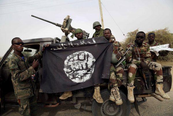 Nigerian soldiers hold up a Boko Haram flag that they seized in the town of Damasak, Nigeria, on March 18, 2015. (Emmanuel Braun/Reuters)