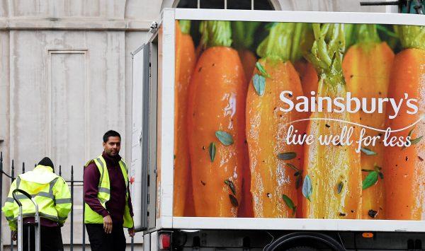 Workers unload a Sainsbury's home delivery van in central London, Britain, April 30, 2018. (Reuters/Toby Melville)