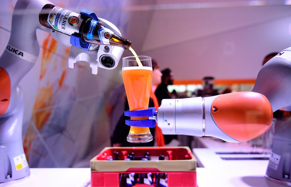 Robots serves beer at the Kuka booth at the Hanover Fair in Hanover, northern Germany, on April 24, 2017. The annual fair showcases industrial innovation products. (Tobias Schwarz/AFP/Getty Images)