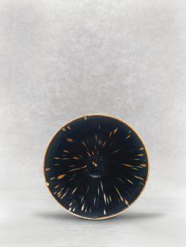 This black-glazed conical bowl, made from Ding kilns in the Northern Song Dynasty (960–1127), is among the few known examples of black-glazed Ding ware and is the most valuable piece from the Linyushanren Collection. The simple brown flecks, evenly and harmoniously scattered across the surface of the glaze, create what is known as the “partridge feather” design. (Christie’s)