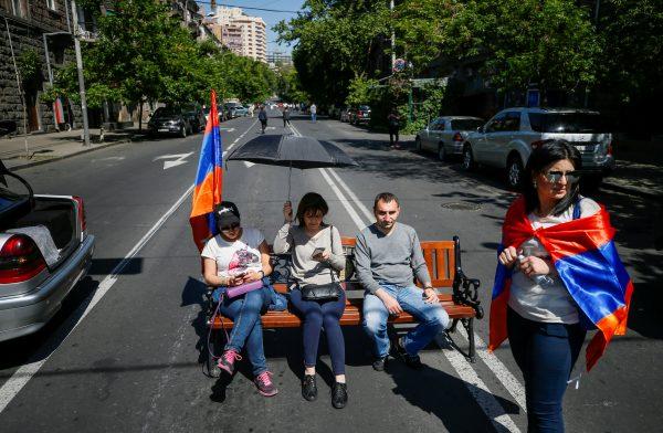 Armenian opposition supporters sit on bench as they block a road after protest movement leader Nikol Pashinyan announced a nationwide campaign of civil disobedience in Yerevan, Armenia May 2, 2018. (Reuters/Gleb Garanich)