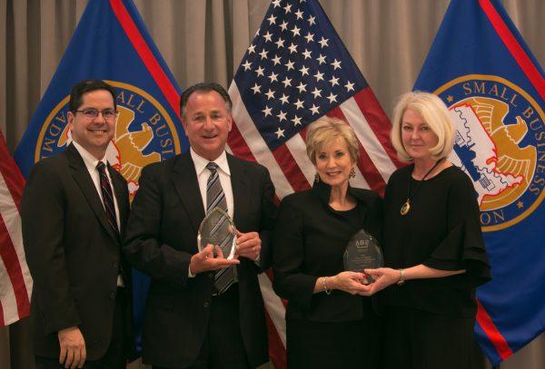 Small Business Administrator Linda McMahon presents the Phoenix Award for Outstanding Small Business Disaster Recovery to Michael and Ginger Marsha in Washington, on Apr. 29, 2018. (Lisa Fan/The Epoch Times)