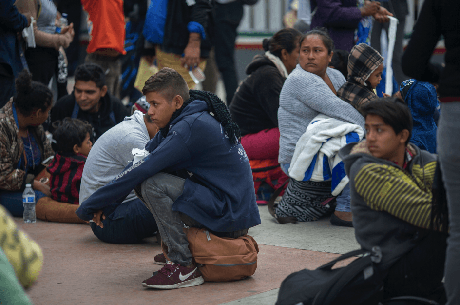 Members of a caravan of Central Americans wait to walk from Mexico into the United States and seek asylum in Tijuana, Mexico, on April 29, 2018. (David McNew/Getty Images)