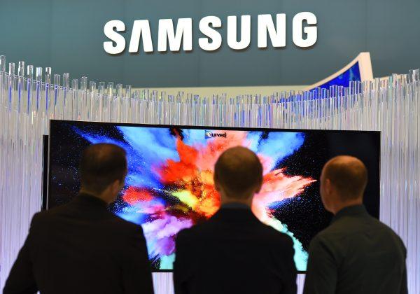 Visitors look at a curved television set displayed at a Samsung booth on the opening day of the consumer electronics trade fair "Internationale Funk Ausstellung " in Berlin on Sept. 5, 2014. (Tobias Schwarz/AFP/Getty Images)