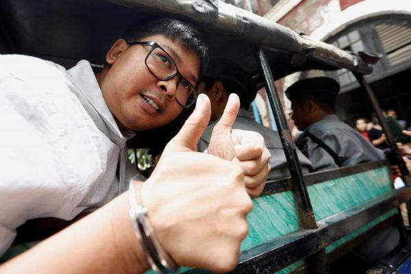 Detained and handcuffed Reuters journalist Wa Lone leaves the court in a police vehicle after a hearing in Yangon, Myanmar, May 2, 2018. (Reuters/Ann Wang)