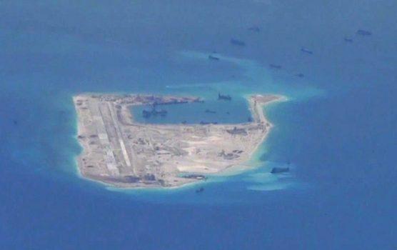 Chinese dredging vessels are purportedly seen in the waters around Fiery Cross Reef in the disputed Spratly Islands in the South China Sea, in this still image from video taken by a P-8A Poseidon surveillance aircraft provided by the United States Navy, on May 21, 2015. (U.S. Navy/Handout via Reuters/File Photo)