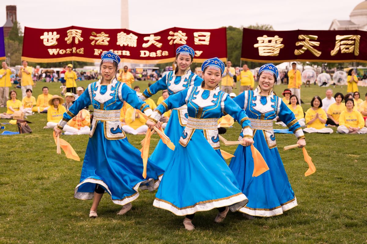 Falun Dafa practitioners perform an ethnic dance at the World Falun Dafa Day celebration on the National Mall in Washington on May 5, 2018. (Samira Bouaou/Epoch Times)