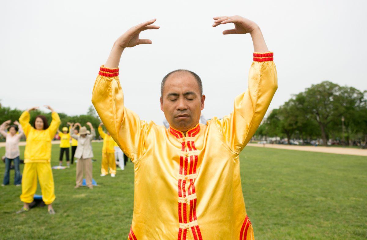 Liu Dexi performing one of the Falun Dafa exercises on the National Mall in Washington on May 5, 2018. (Lisa Fan/Epoch Times)