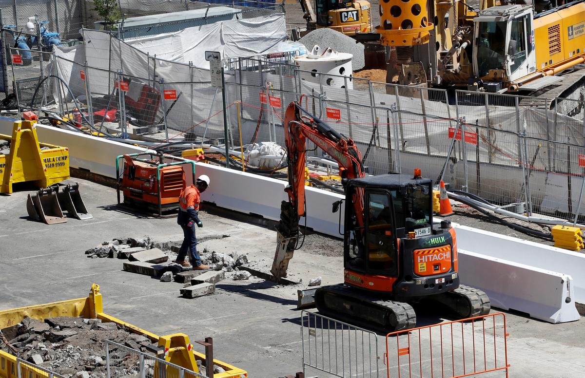 A worker looks on as a drill breaks the pavement on a construction site next to Barangaroo building complex in Sydney's central business district (CBD) Australia, Nov. 9, 2017. (Reuters/Daniel Munoz/File Photo)