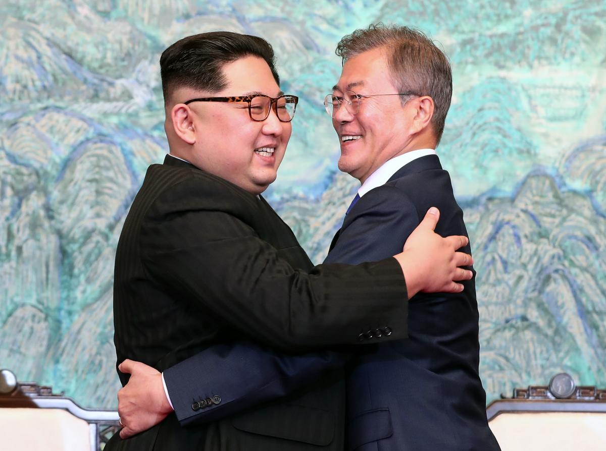 North Korean leader Kim Jong Un (L) and South Korean President Moon Jae-in (R) embrace after signing the Panmunjom Declaration during the Inter-Korean Summit at the Peace House on April 27 in Panmunjom, South Korea. (Korea Summit Press Pool/Getty Images)