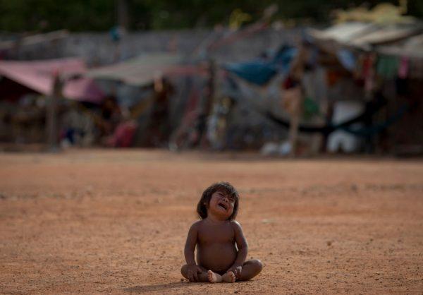 A Venezuelan indigenous refugee child cries at the Pintolandia shelter in the city of Boa Vista, northern Brazil, on Feb. 24. Venezuela's infant mortality rose 30 percent and maternal mortality rate skyrocketed by 65 percent last year, according to UNHCR. (MAURO PIMENTEL/AFP/Getty Images)