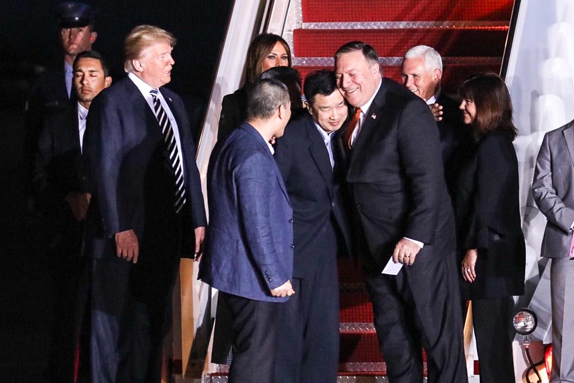 President Donald Trump (L) looks on as Tony Kim, who arrived back in the United States after being imprisoned in North Korea, hugs Secretary of State Mike Pompeo, in Maryland, on May 10, 2018. (Samira Bouaou/The Epoch Times)