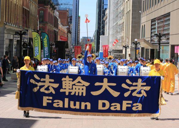 Falun Dafa adherents take part in a parade to celebrate Falun Dafa Day in Ottawa on May 9, 2018. (Jonathon Ren/The Epoch Times)