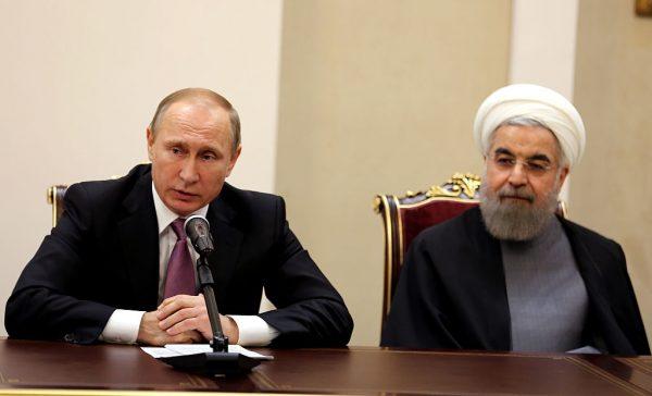 Iranian President Hassan Rouhani (R) and Russian counterpart Vladimir Putin hold a press conference following the Gas Exporting Countries Forum (GECF) summit in Tehran on Nov. 23, 2015. (Photo credit should read ATTA KENARE/AFP/Getty Images)
