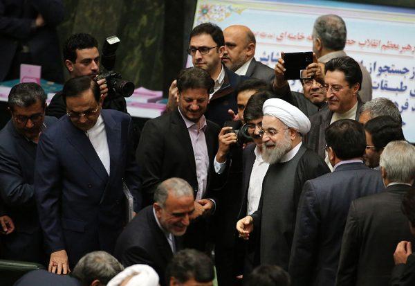 Iranian President Hassan Rouhani (C) arrives to parliament ahead of presenting the proposed annual budget in the capital Tehran, on January 17, 2016, after sanctions were lifted under Tehran's nuclear deal with world powers. (Photo credit should read ATTA KENARE/AFP/Getty Images)