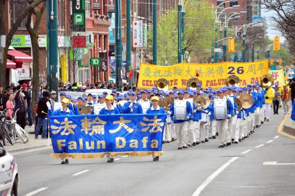 Falun Dafa adherents perform in a parade to celebrate Falun Dafa Day in Toronto on May 12, 2018. (Evan Ning/The Epoch Times)