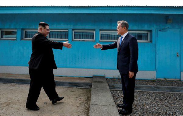 South Korean President Moon Jae-in and North Korean leader Kim Jong Un shake hands at the truce village of Panmunjom inside the demilitarized zone separating the two Koreas on April 27, 2018. (Korea Summit Press Pool/Pool via Reuters)