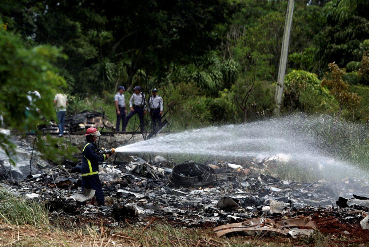 Firefighters work in the wreckage of a Boeing 737 plane that crashed in the agricultural area of Boyeros, around 12 miles south of Havana, shortly after taking off from Havana's main airport in Cuba on May 18, 2018. (Reuters/Alexandre Meneghini)