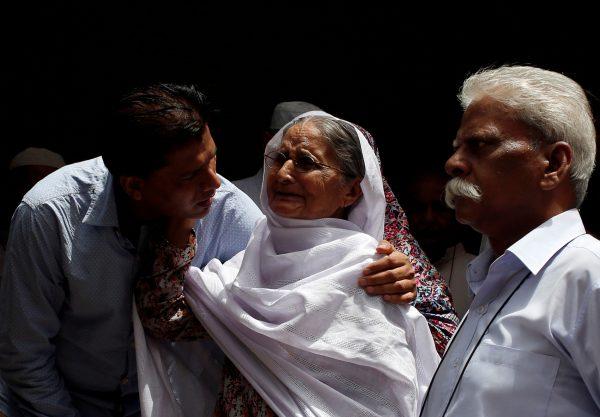Aziz Shaikh (L), father of Sabika Aziz Sheikh, a Pakistani exchange student, who was killed with others when a gunman attacked Santa Fe High School in Santa Fe, Texas on comforts a relative in Karachi, Pakistan May 19, 2018. (REUTERS/Akhtar Soomro)