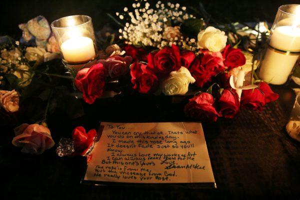 A note is left behind by an attendee on the vigil table during a vigil for the victims of a shooting at Santa Fe High School that left several dead and injured in Santa Fe, Texas, U.S., May 18, 2018. (Reuters/Pu Ying Huang)