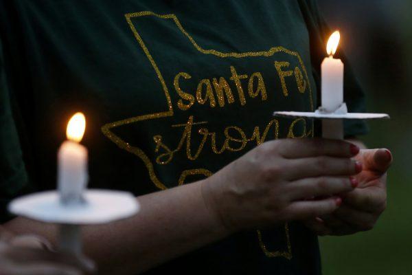 Mourners hold candles during a vigil in memory of the victims killed in a shooting at Santa Fe High School in League City, Texas, U.S., May 20, 2018. (Reuters/Jonathan Bachman/File Photo)