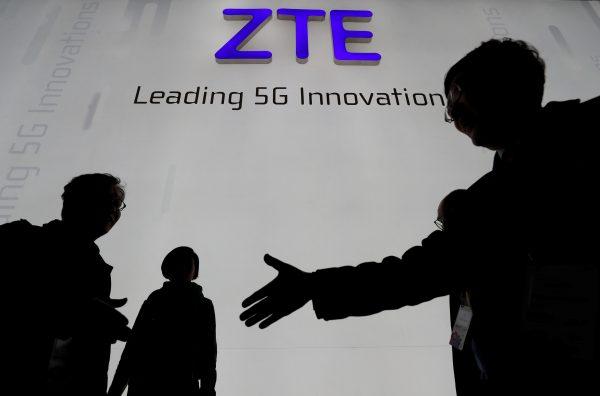 Visitors pass in front of the Chinese telecoms equipment firm ZTE, at the Mobile World Congress in Barcelona, Spain, on Feb. 26, 2018. (Yves Herman/File Picture/Reuters)