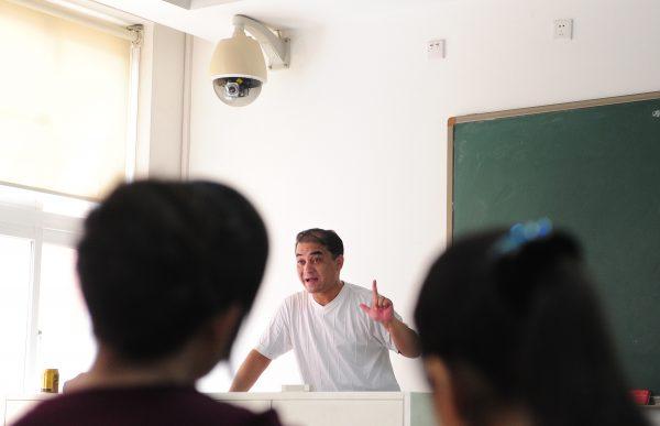 A security surveillance camera mounted above the teacher's podium as university professor Ilham Tohti lectures in a classroom in Beijing, China on June 12, 2010. (Frederic J. Brown/AFP/Getty Images)