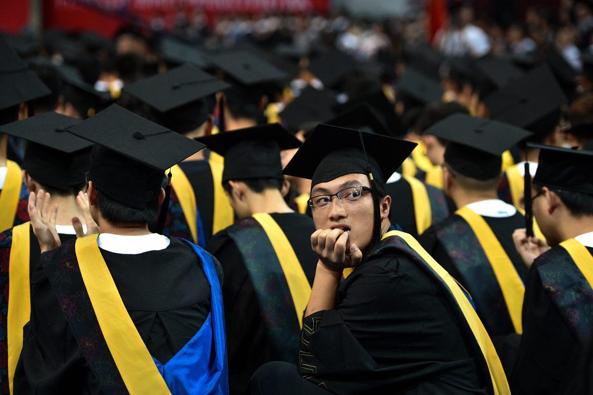 Students at the Huazhong University of Science and Technology graduation ceremony in a sports stadium in Wuhan, Hubei Province, China, on June 20, 2017. (STR/AFP/Getty Images)