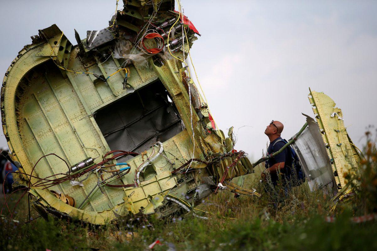 A Malaysian air crash investigator inspects the crash site of Malaysia Airlines Flight MH17, near the village of Hrabove (Grabovo) in Donetsk region, Ukraine, on July 22, 2014. (Maxim Zmeyev/Reuters)