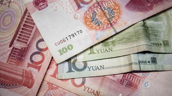 This photo illustration taken on September 29, 2016 shows Chinese 100 yuan, 10 yuan, and one yuan notes in Beijing. (FRED DUFOUR/AFP/Getty Images)