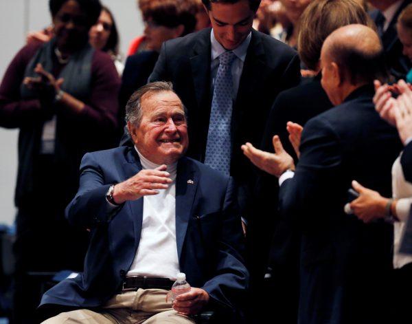 Former President George H. W. Bush is brought into the auditorium where his son Former United States President George W. Bush speaks about his new book titled "41: A Portrait of My Father" at the George Bush Presidential Library Center in College Station, Texas on Nov. 11, 2014. (REUTERS/Bob Daemmrich/Pool/File Photo)